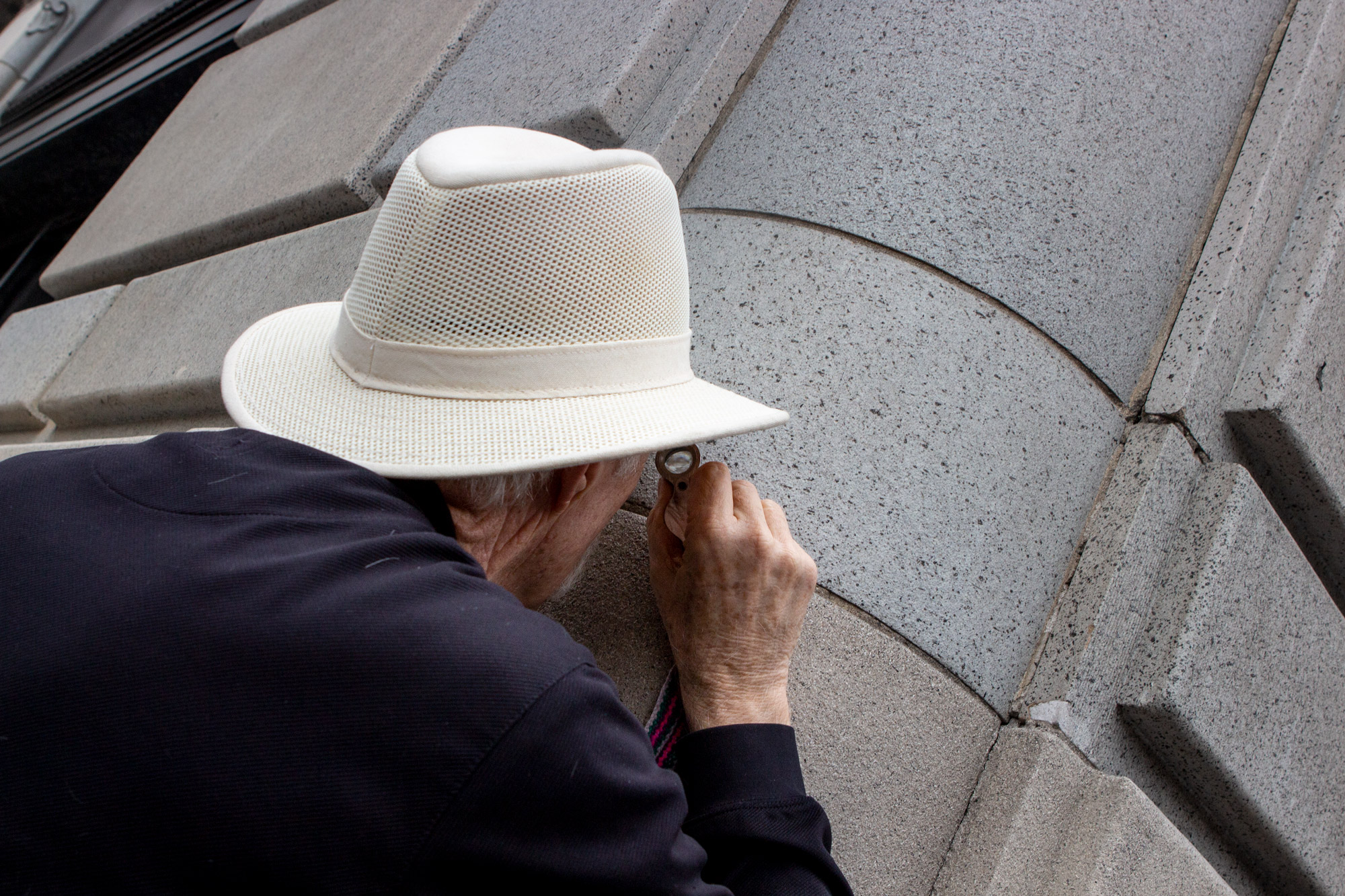 Geologist and SDSU Professor Emeritus Pat Abbott inspects the facade of the historic Spreckel's building on Broadway in downtown San Diego on May 23, 2018.